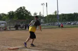 person running off of first base while playing softball