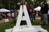 person pouring paint on letter "A" sign