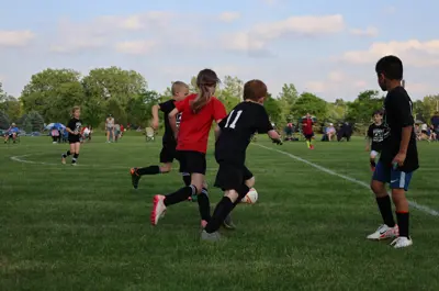 young children playing soccer