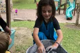 child doing pottery