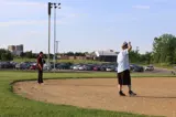 two people standing in the infield playing softball