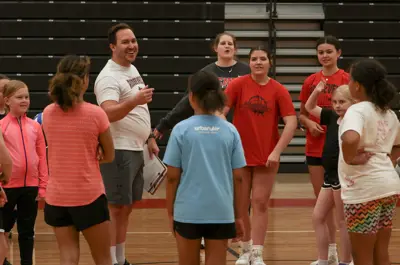 coach talking to volleyball players