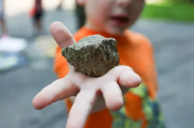 camper holding a rock to the camera