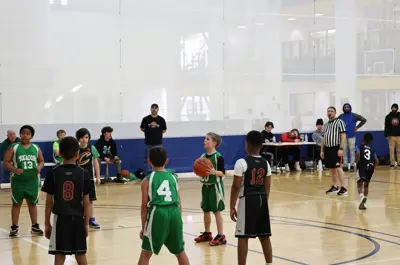 young children playing basketball, shooting a foul shot