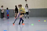 Girl doing field hockey drills 