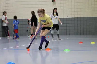 Girl doing field hockey drills 