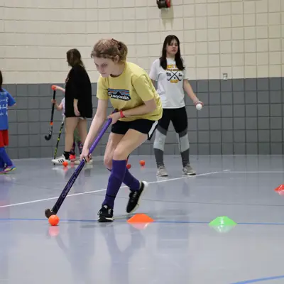 Girl doing field hockey drills 