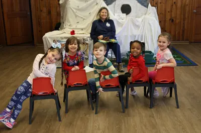 preschoolers smiling with their teacher