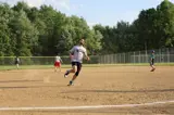 man running to third base during softball game