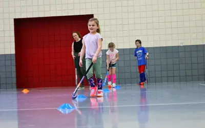 Young girl playing field hockey