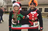 Two runners wearing a shared Christmas sweater