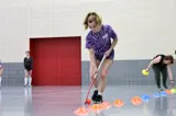 Girl doing field hockey drills 