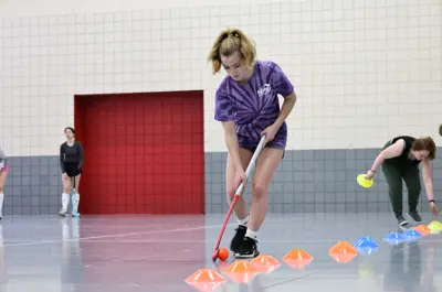 Girl doing field hockey drills 