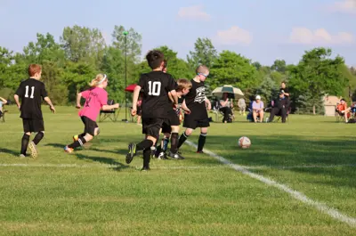 young children playing soccer