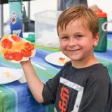 Camper holding smiley face food