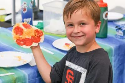 Camper holding smiley face food