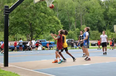 Youth basketball players waiting to catch a rebound