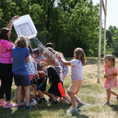 campers getting a water bucket thrown on them